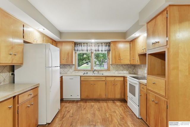 2417 Fairway Dr, Fremont, NE 68025 - kitchen with white appliances, a sink, light wood-style floors, decorative backsplash, and light countertops