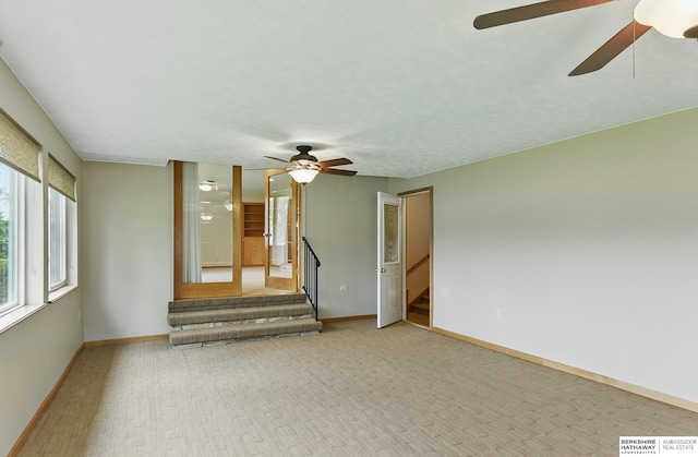 2417 Fairway Dr, Fremont, NE 68025 - unfurnished living room with a ceiling fan, baseboards, and carpet floors