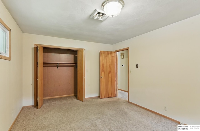 2417 Fairway Dr, Fremont, NE 68025 - unfurnished bedroom featuring a closet, light colored carpet, and baseboards