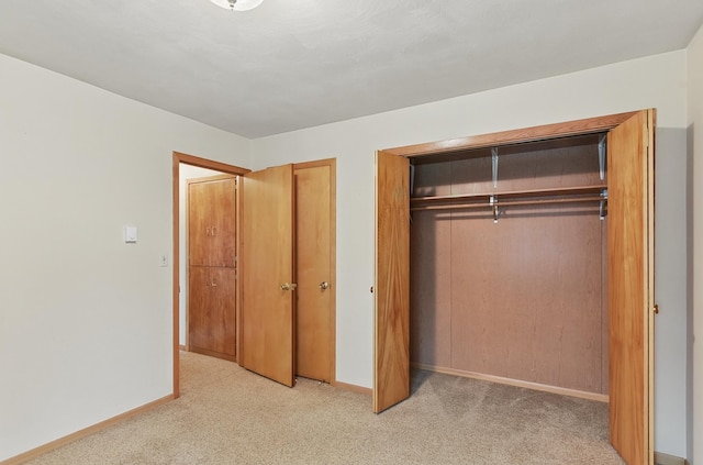 2417 Fairway Dr, Fremont, NE 68025 - unfurnished bedroom featuring light colored carpet, baseboards, and multiple closets