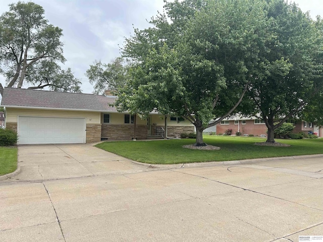 2417 Fairway Dr, Fremont, NE 68025 - view of front facade with a garage, driveway, a front yard, and stone siding