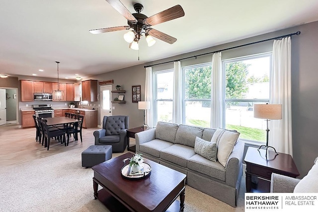 18914 C St, Omaha, NE 68130 - living room featuring healthy amount of natural light, a ceiling fan, recessed lighting, and light carpet