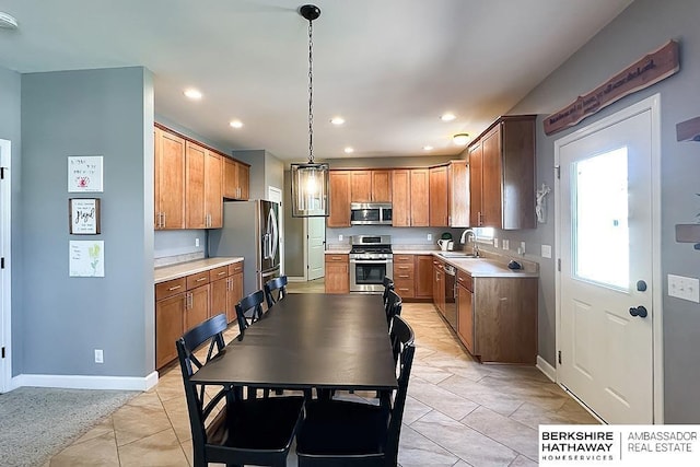 18914 C St, Omaha, NE 68130 - kitchen with stainless steel appliances, light countertops, baseboards, recessed lighting, and light tile patterned flooring