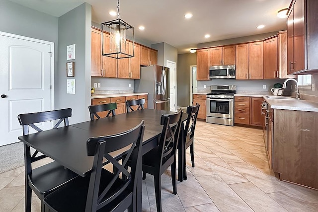 18914 C St, Omaha, NE 68130 - kitchen with stainless steel appliances, recessed lighting, light countertops, light tile patterned flooring, and brown cabinetry