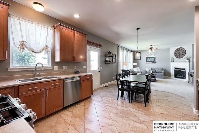 18914 C St, Omaha, NE 68130 - kitchen with stainless steel dishwasher, a sink, a ceiling fan, open floor plan, and brown cabinets