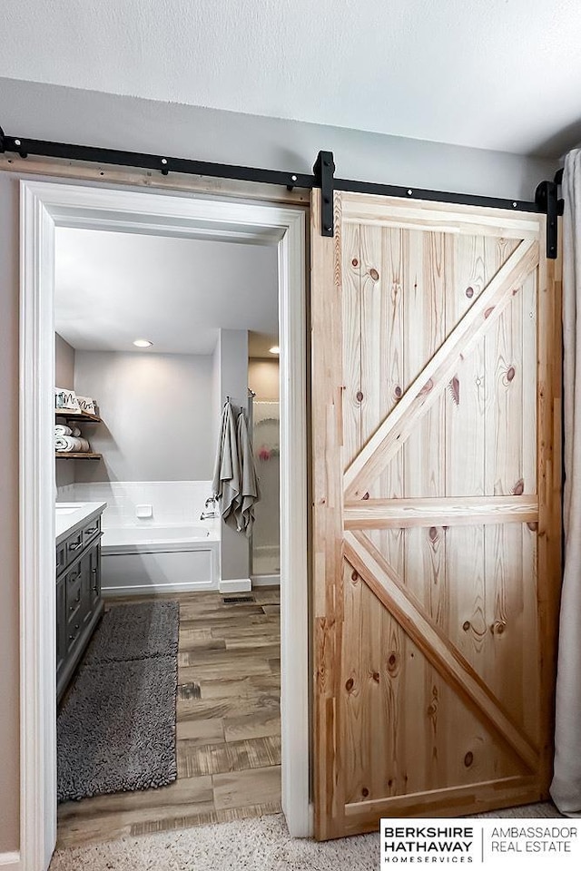 18914 C St, Omaha, NE 68130 - bathroom featuring wood finished floors and a tub