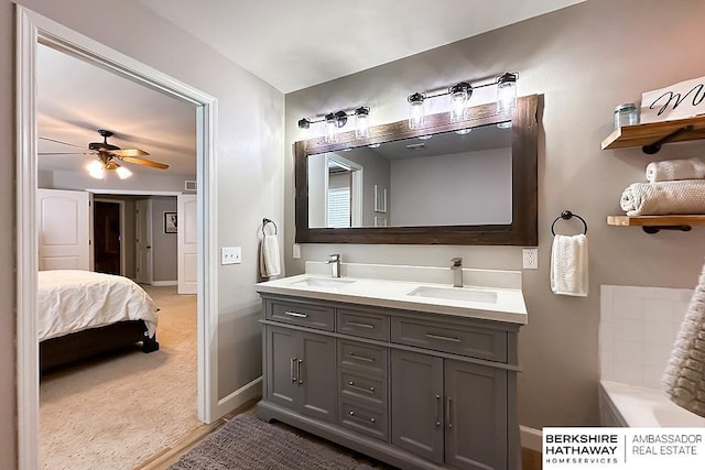 18914 C St, Omaha, NE 68130 - bathroom with double vanity, a ceiling fan, and baseboards