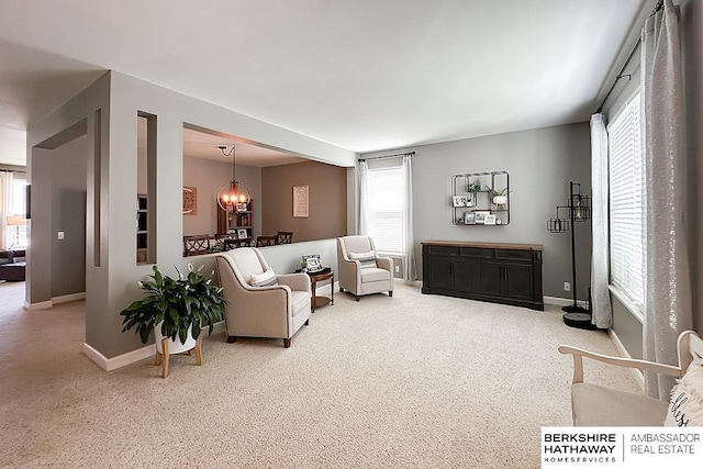 18914 C St, Omaha, NE 68130 - living room with a chandelier, carpet flooring, and baseboards