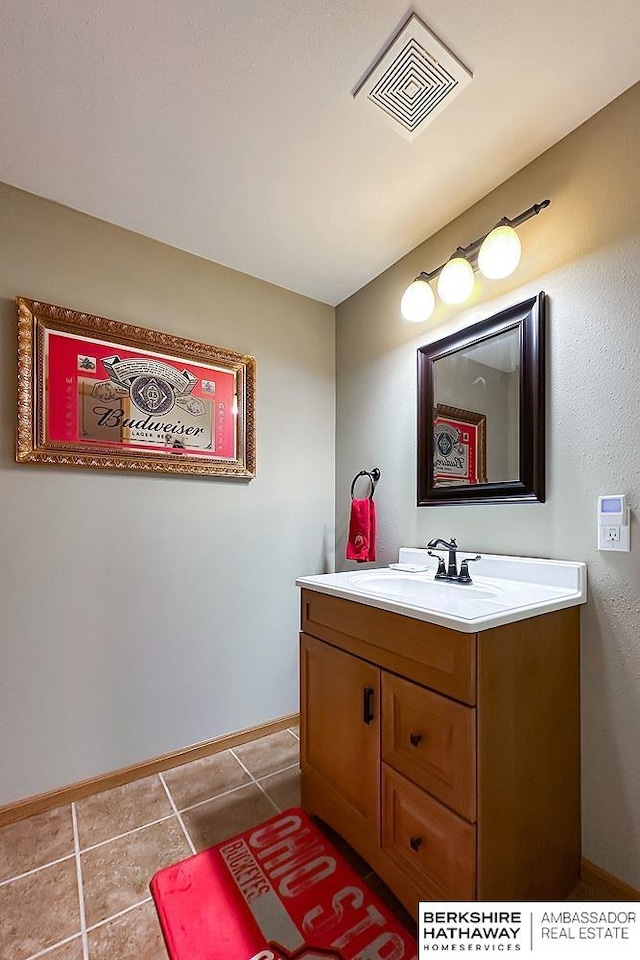 18914 C St, Omaha, NE 68130 - bathroom with vanity, baseboards, and tile patterned floors