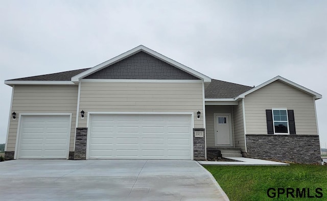 17063 Reynolds St, Bennington, NE 68007 - view of front of home with stone siding, an attached garage, entry steps, and driveway