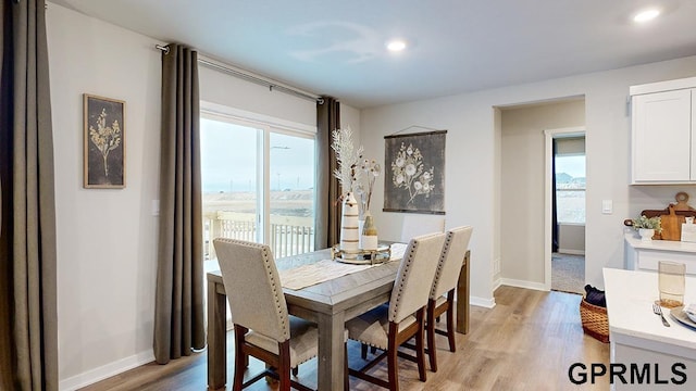 17063 Reynolds St, Bennington, NE 68007 - dining room with light wood-style flooring, baseboards, and recessed lighting