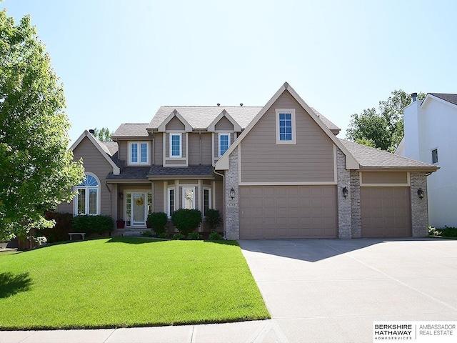5103 N 140th St, Omaha, NE 68164 - view of front of house featuring driveway, a front lawn, an attached garage, and brick siding