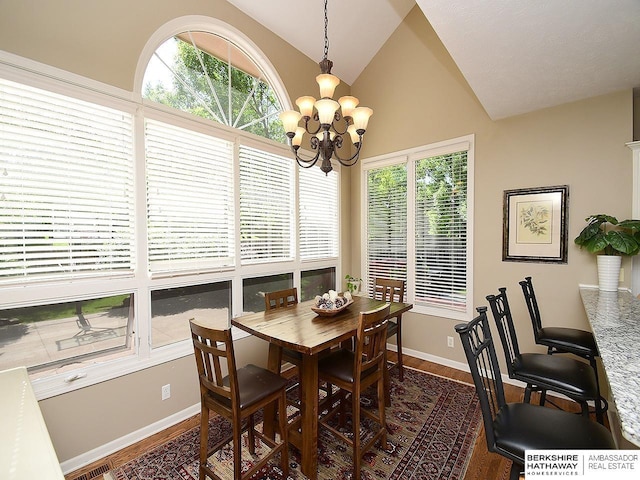 5103 N 140th St, Omaha, NE 68164 - dining space featuring vaulted ceiling, dark wood finished floors, a chandelier, and baseboards