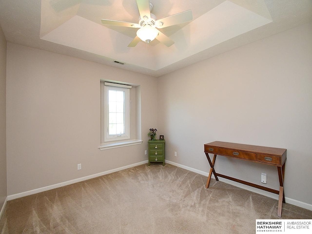 5103 N 140th St, Omaha, NE 68164 - spare room featuring a raised ceiling, light carpet, a ceiling fan, and baseboards