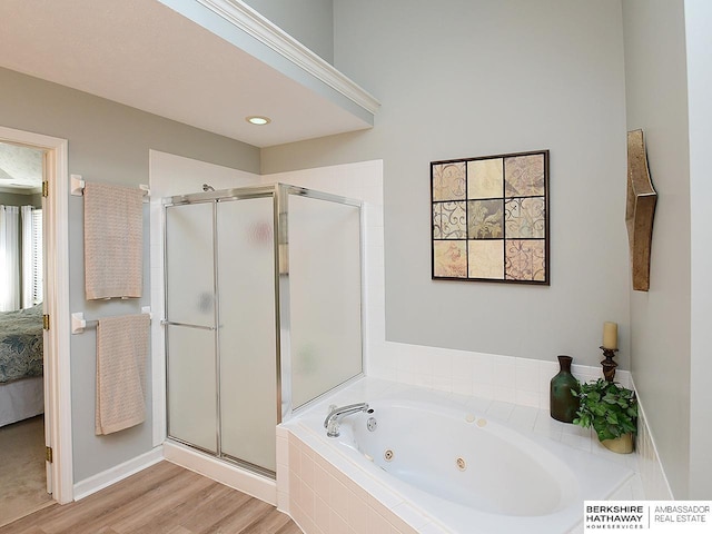 5103 N 140th St, Omaha, NE 68164 - bathroom with a shower stall, a tub with jets, connected bathroom, and wood finished floors