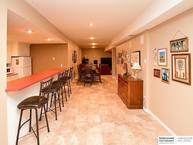 5103 N 140th St, Omaha, NE 68164 - dining room featuring recessed lighting, baseboards, and a dry bar
