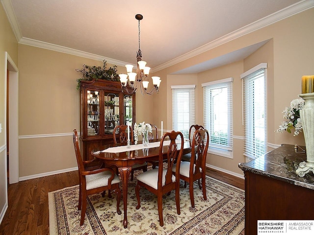 5103 N 140th St, Omaha, NE 68164 - dining area featuring crown molding, a chandelier, wood finished floors, and baseboards