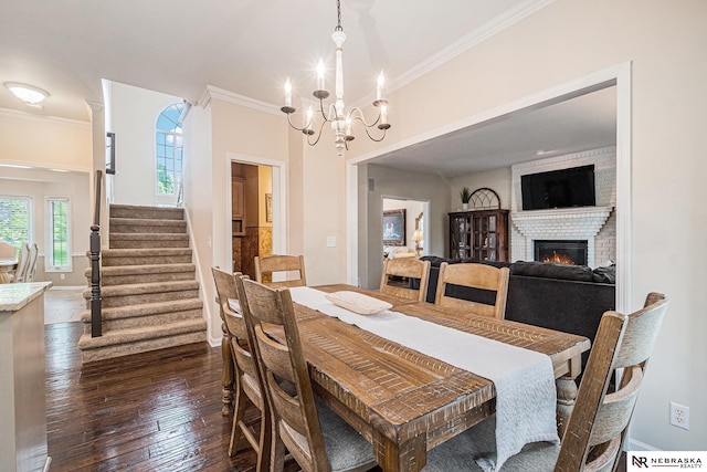 2221 S 181st Cir, Omaha, NE 68130 - dining area with crown molding, stairs, a chandelier, a fireplace, and dark wood finished floors