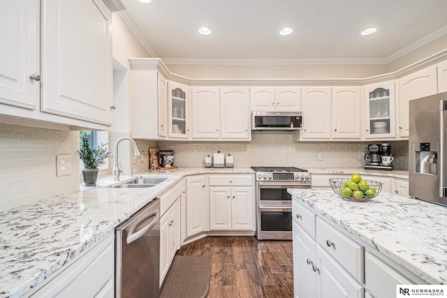 2221 S 181st Cir, Omaha, NE 68130 - kitchen featuring stainless steel appliances, dark wood-style flooring, ornamental molding, glass insert cabinets, and light stone countertops