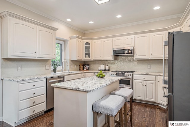 2221 S 181st Cir, Omaha, NE 68130 - kitchen with appliances with stainless steel finishes, dark wood-style floors, crown molding, light stone countertops, and recessed lighting