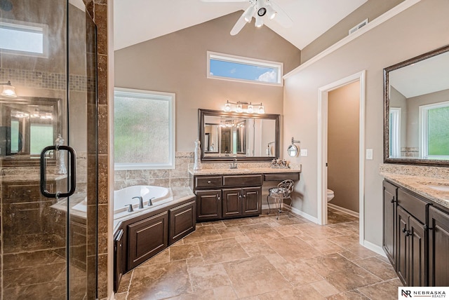 2221 S 181st Cir, Omaha, NE 68130 - bathroom featuring two vanities, a shower stall, a garden tub, a ceiling fan, and high vaulted ceiling