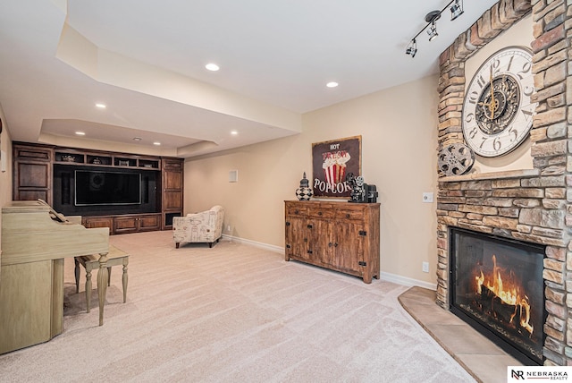 2221 S 181st Cir, Omaha, NE 68130 - living room featuring carpet flooring, recessed lighting, a stone fireplace, and a raised ceiling