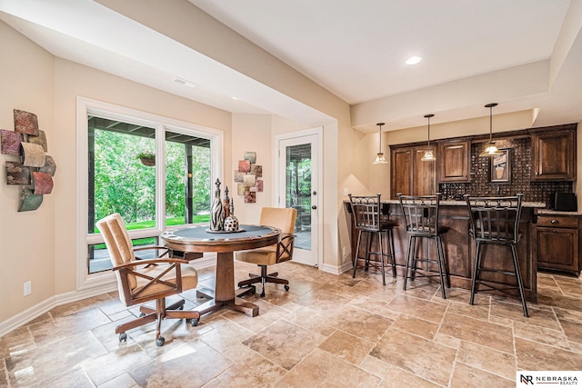 2221 S 181st Cir, Omaha, NE 68130 - dining room featuring stone tile floors, recessed lighting, and bar