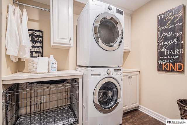 2221 S 181st Cir, Omaha, NE 68130 - laundry room with estacked washer and dryer, cabinet space, and dark wood-style flooring