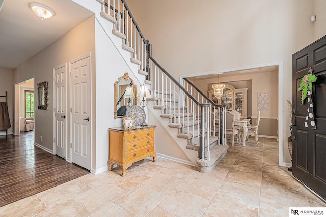 2221 S 181st Cir, Omaha, NE 68130 - foyer entrance featuring stairs, a chandelier, and a high ceiling
