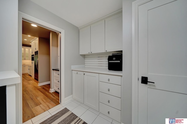6602 Pheasant Run Pl, Lincoln, NE 68516 - kitchen featuring stainless steel fridge, white cabinetry, recessed lighting, light countertops, and baseboards