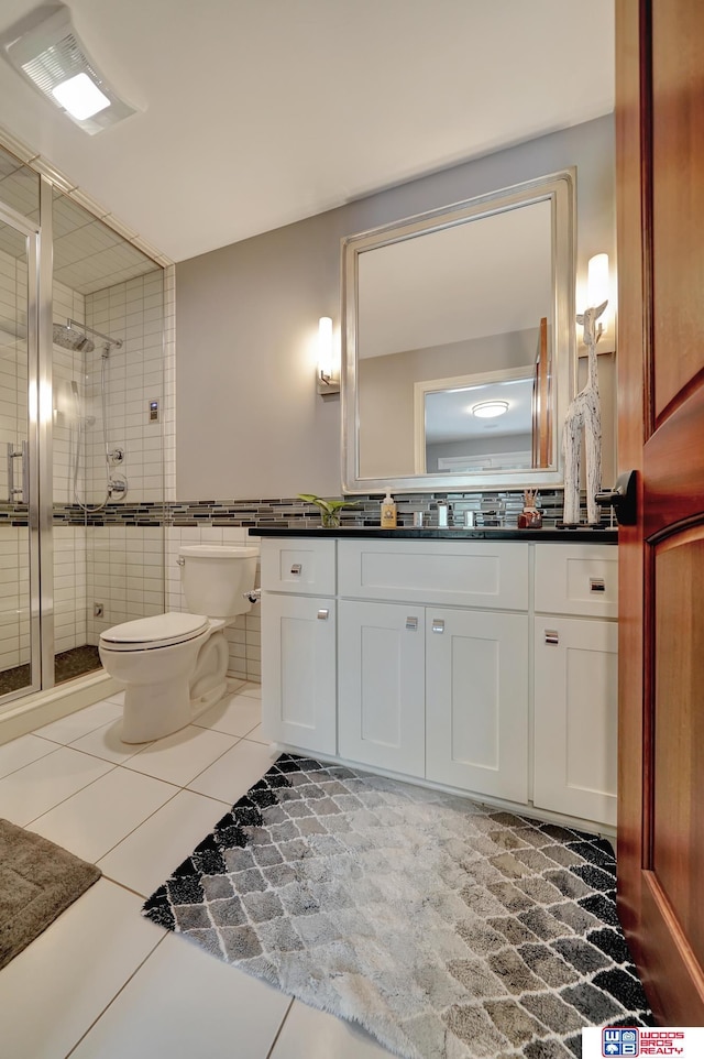 6602 Pheasant Run Pl, Lincoln, NE 68516 - full bath featuring toilet, vanity, a shower stall, tile patterned floors, and tile walls