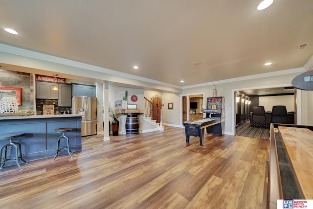 6602 Pheasant Run Pl, Lincoln, NE 68516 - living room featuring stairs, light wood finished floors, baseboards, recessed lighting, and ornamental molding