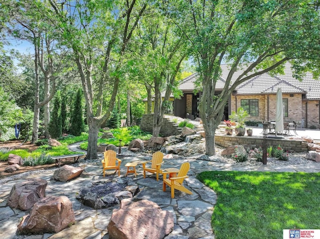 6602 Pheasant Run Pl, Lincoln, NE 68516 - view of patio with an outdoor fire pit