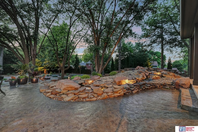 6602 Pheasant Run Pl, Lincoln, NE 68516 - pool at dusk featuring a patio