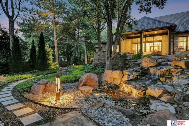 6602 Pheasant Run Pl, Lincoln, NE 68516 - yard at dusk featuring a garden pond