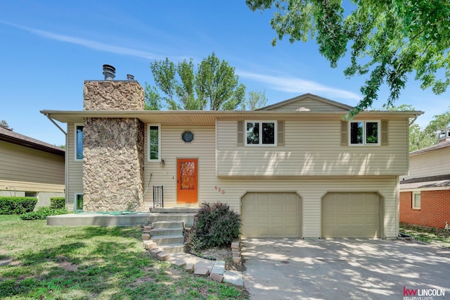 430 N 86th St, Lincoln, NE 68505 - raised ranch featuring a garage, a chimney, and concrete driveway