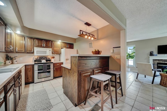 430 N 86th St, Lincoln, NE 68505 - kitchen with white appliances, light tile patterned floors, a textured ceiling, light countertops, and a sink