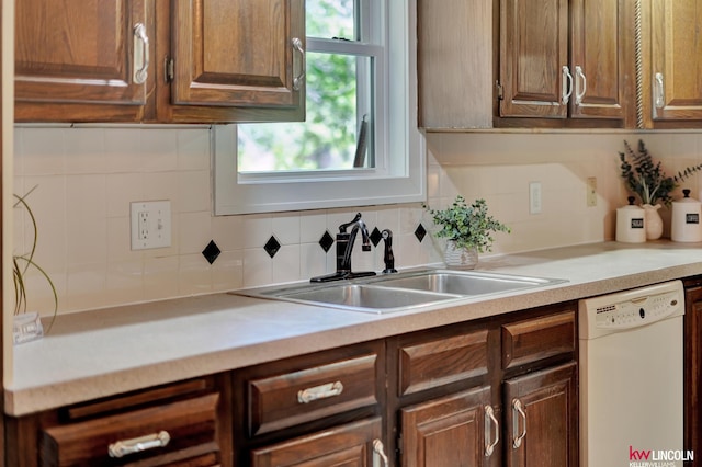 430 N 86th St, Lincoln, NE 68505 - kitchen featuring white dishwasher, a sink, light countertops, and backsplash