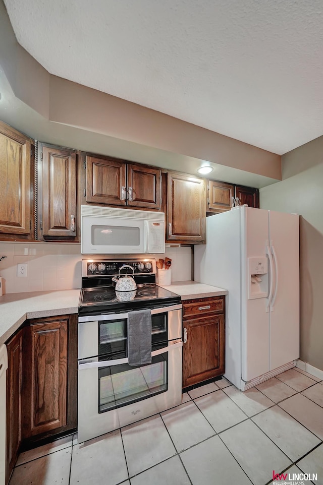 430 N 86th St, Lincoln, NE 68505 - kitchen featuring white appliances, light countertops, light tile patterned flooring, and tasteful backsplash