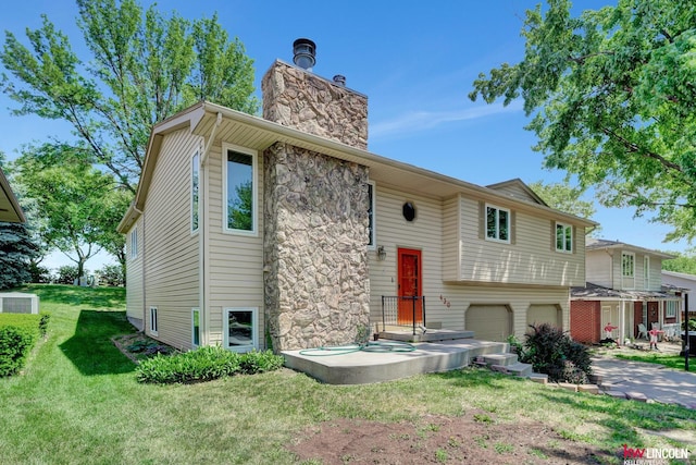 430 N 86th St, Lincoln, NE 68505 - split foyer home featuring a chimney, a garage, a front yard, stone siding, and central AC unit
