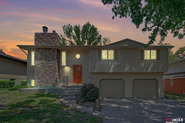 430 N 86th St, Lincoln, NE 68505 - view of front of home featuring a garage, a chimney, and concrete driveway