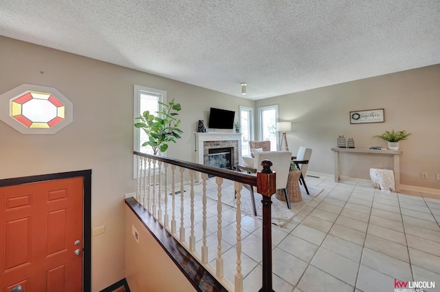 430 N 86th St, Lincoln, NE 68505 - entryway featuring healthy amount of natural light, a fireplace, a textured ceiling, light tile patterned flooring, and baseboards