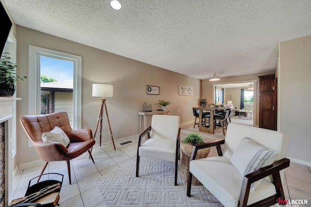430 N 86th St, Lincoln, NE 68505 - living room featuring plenty of natural light, light tile patterned flooring, a textured ceiling, and baseboards