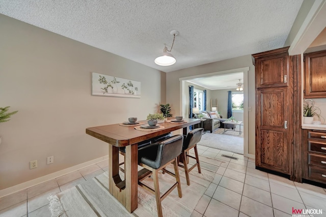 430 N 86th St, Lincoln, NE 68505 - dining room featuring light tile patterned floors, baseboards, and a textured ceiling