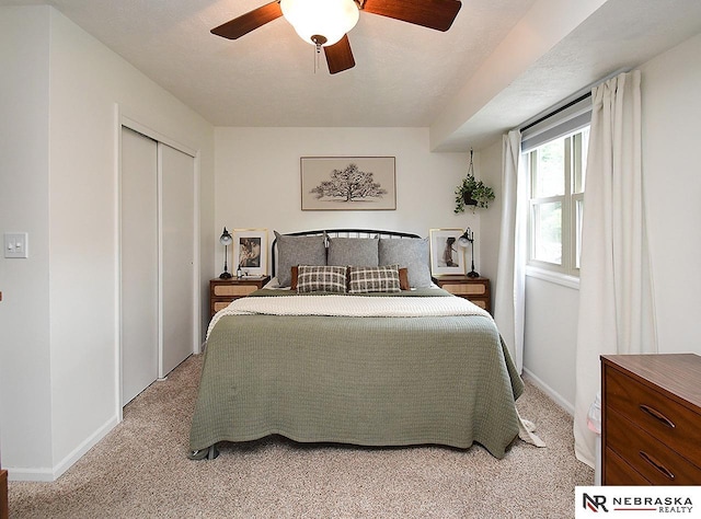 4219 Browning St, Lincoln, NE 68516 - bedroom with light colored carpet, a closet, baseboards, and a ceiling fan