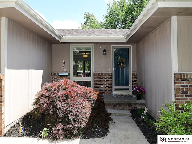 4219 Browning St, Lincoln, NE 68516 - property entrance with brick siding and a shingled roof