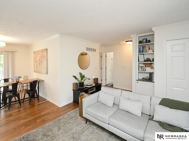 4219 Browning St, Lincoln, NE 68516 - living area featuring wood finished floors, crown molding, and baseboards