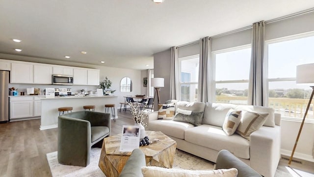 7814 N 169th St, Bennington, NE 68007 - living room featuring light wood-style floors, recessed lighting, and baseboards