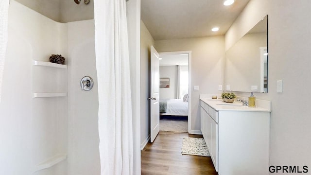7814 N 169th St, Bennington, NE 68007 - full bath featuring wood finished floors, connected bathroom, vanity, a shower with shower curtain, and recessed lighting
