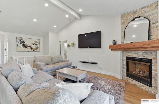 4019 N 147th St, Omaha, NE 68116 - living area featuring beam ceiling, wood finished floors, a stone fireplace, recessed lighting, and high vaulted ceiling